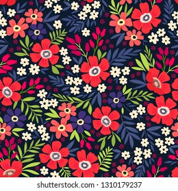 Trendy seamless vector floral pattern. Endless print made of small multi-color flowers, leaves and berries. Summer and spring motifs. Dark blue background.Vector illustration.
