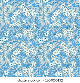 Trendy seamless vector floral pattern. Endless print of light blue flowers, leaves and berries. Summer and spring motifs in blue tones.  Vector illustration.