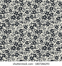 Trendy seamless vector floral pattern. Endless print made of small black flowers. Summer and spring motifs. White background. Vector illustration.