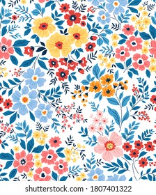 Trendy seamless vector floral pattern. Seamless print made of small multicolored flowers and blue leaves . Summer and spring motifs. White background. Vector illustration.