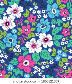 Trendy seamless vector floral pattern. Endless print made of small colorful flowers, leaves and berries. Summer and spring motifs. Blue background. Stock vector illustration.