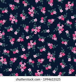 Trendy seamless vector floral pattern of small  flowers on navy background 