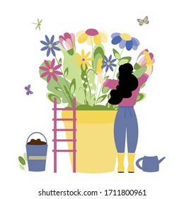 Trendy spring, gardening people concept. Stylish girl with fashionable hairstyle cares for spring flowers