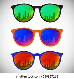 Trendy sunglasses with colorful lens and frame reflect city sky view in summer