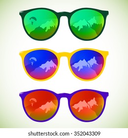 Trendy sunglasses with colorful lens and frame reflect mountains and skydiver parachute, vector illustration