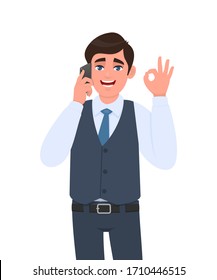 Trendy young business man in waistcoat speaking on phone and showing okay, OK gesture sign. Person calling to mobile, making cool symbol. Male talking over cellphone. Cartoon design in vector style.