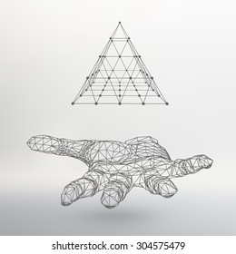 triangle pyramid on the arm. The hand holding a pyramid. Polygon triangle. Polygonal hand. White background. The shadow of the objects in the background.