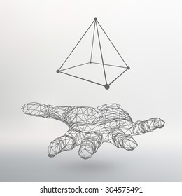 triangle pyramid on the arm. The hand holding a pyramid. Polygon triangle. Polygonal hand. White background. The shadow of the objects in the background.