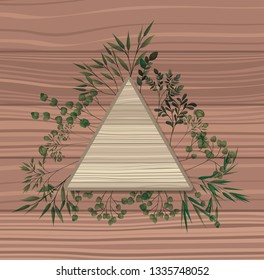 triangular frame with laurel leafs wooden background