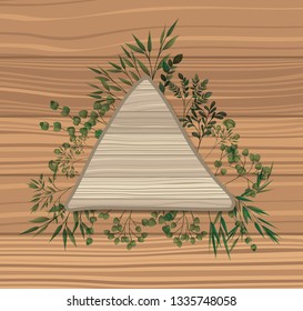 triangular frame with laurel leafs wooden background