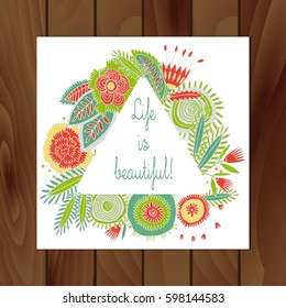 triangular frame made of flowers in vintage style.On wooden background