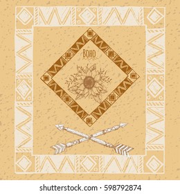 Tribal arrow in ethnic pattern with feathers and wild flowers