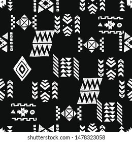 Tribal ethnic background. Stylish primitive geometric seamless pattern. Trendy print grunge texture vector illustration. Monochrome fabric textile. White on black