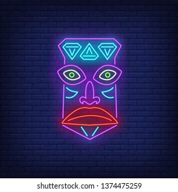 Tribal mask neon sign. Tiki idol, ancient culture design. Night bright neon sign, colorful billboard, light banner. Vector illustration in neon style.