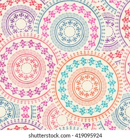 Tribal seamless background with archaic geometric ornament. Primitive ethnic style with hand drawn circles. Happy colorful color palette