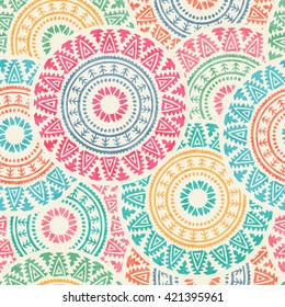 Tribal seamless background with archaic geometric ornament. Primitive ethnic style with hand drawn circles. Happy colorful color palette