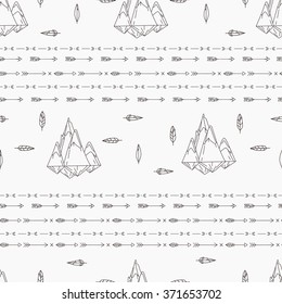 Tribal seamless pattern with arrows, mountains and feathers.