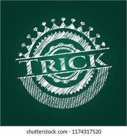 Trick chalk emblem written on a blackboard