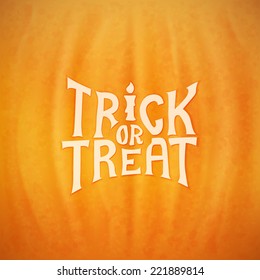 Trick or treat calligraphic vector lettering over a background of a Halloween pumpkin texture