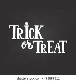 Trick or treat - Halloween party hand drawn lettering phrase, isolated on the black chalkboard. Fun brush ink inscription for photo overlays, typography greeting card or t-shirt print, poster design