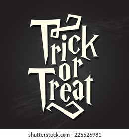 Trick or treat halloween quote on black chalkboard background