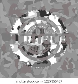 Trifle written on a grey camouflage texture