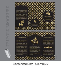 Tri-fold brochure template with forget-me-not flower pattern in gold and black colors