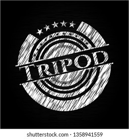 Tripod chalk emblem written on a blackboard