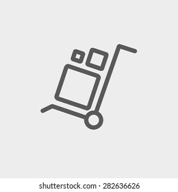 Trolley with boxes icon thin line for web and mobile, modern minimalistic flat design. Vector dark grey icon on light grey background.