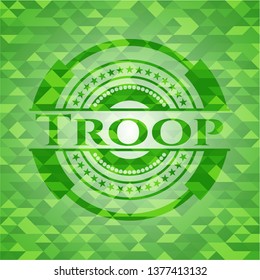 Troop green emblem with triangle mosaic background