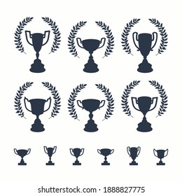 Trophy cups set. Black silhouettes of award cups in different shapes with laurel wreath and ribbon on a white background on white background - 1st place winner trophies. Flat style vector illustration