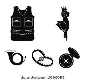 A trophy in his hand, a steel trap, a hunting vest with patronage, a horn..Hunting set collection icons in black style vector symbol stock illustration web.