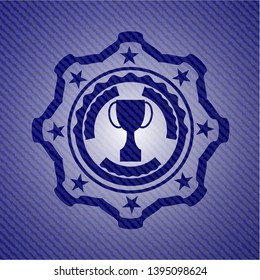 trophy icon inside badge with denim background