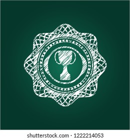 trophy icon inside chalk emblem written on a blackboard