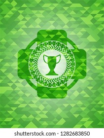 trophy icon inside green emblem with triangle mosaic background