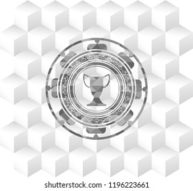 trophy icon inside grey badge with geometric cube white background