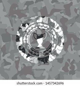 trophy icon inside grey camouflaged emblem