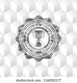 trophy icon inside grey emblem with geometric cube white background