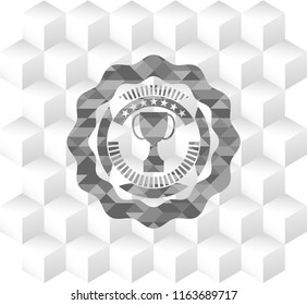 trophy icon inside grey emblem with geometric cube white background