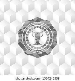 trophy icon inside grey emblem with geometric cube white background