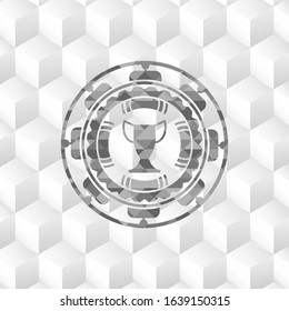 trophy icon inside grey emblem with geometric cube white background