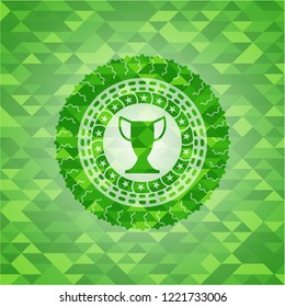 trophy icon inside realistic green emblem. Mosaic background