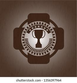 trophy icon inside realistic wood emblem