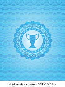 trophy icon inside sky blue water wave style emblem.