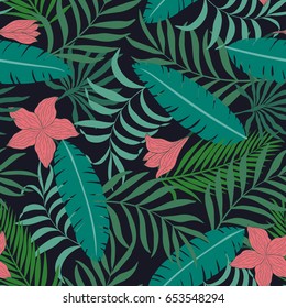 Tropical background with palm leaves and flowers. Seamless floral pattern