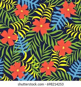 Tropical background with palm leaves and flowers. Seamless floral pattern
