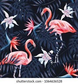 Tropical birds pink flamingo exotic flowers bird of paradise (strelitzia) dark blue palm leaves black background seamless vector pattern