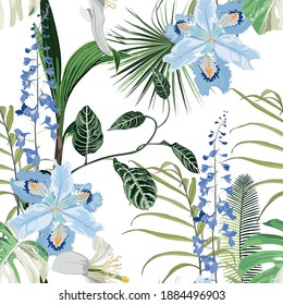 Tropical blue flowers and tropical leaves, light background. Seamless pattern. Jungle foliage illustration. Exotic plants. Summer beach floral design. Paradise nature.