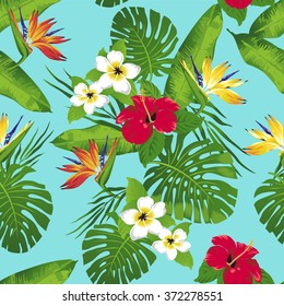 Tropical flowers and leaves on blue background. Seamless. Vector.
