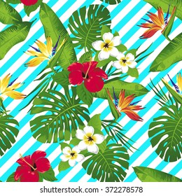 Tropical flowers and leaves on striped background. Seamless. Vector.